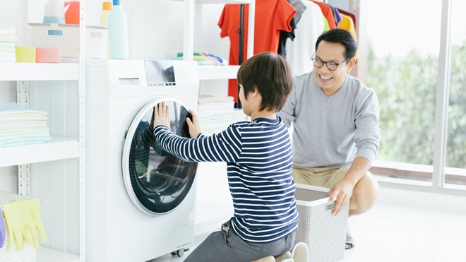 father and son doing laundry